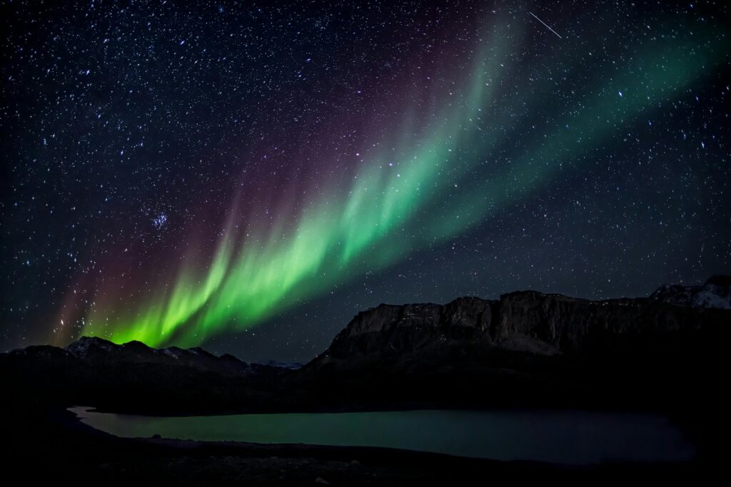 Mesmerizing aurora borealis illuminating the night sky over a serene landscape, capturing nature's beauty.