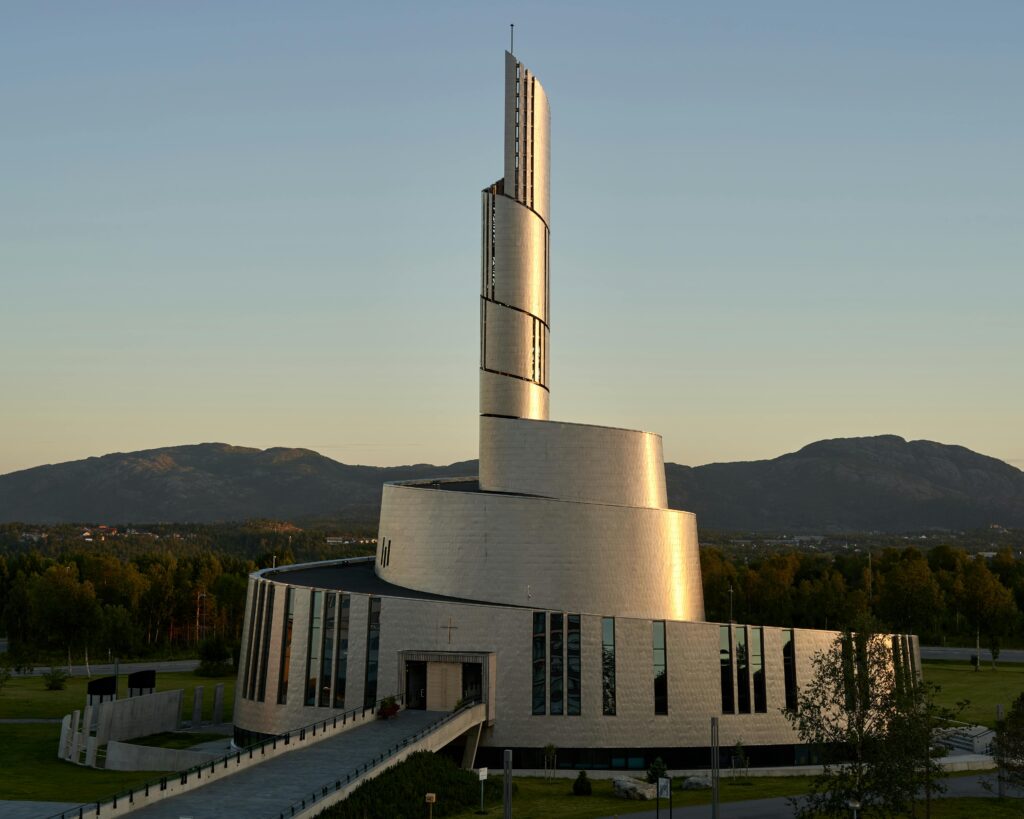 The modern Northern Lights Cathedral beautifully illuminated during dusk in Alta, Norway.